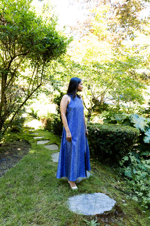 Model wearing the Indigo Diamond Halter Maxi Dress in a garden setting