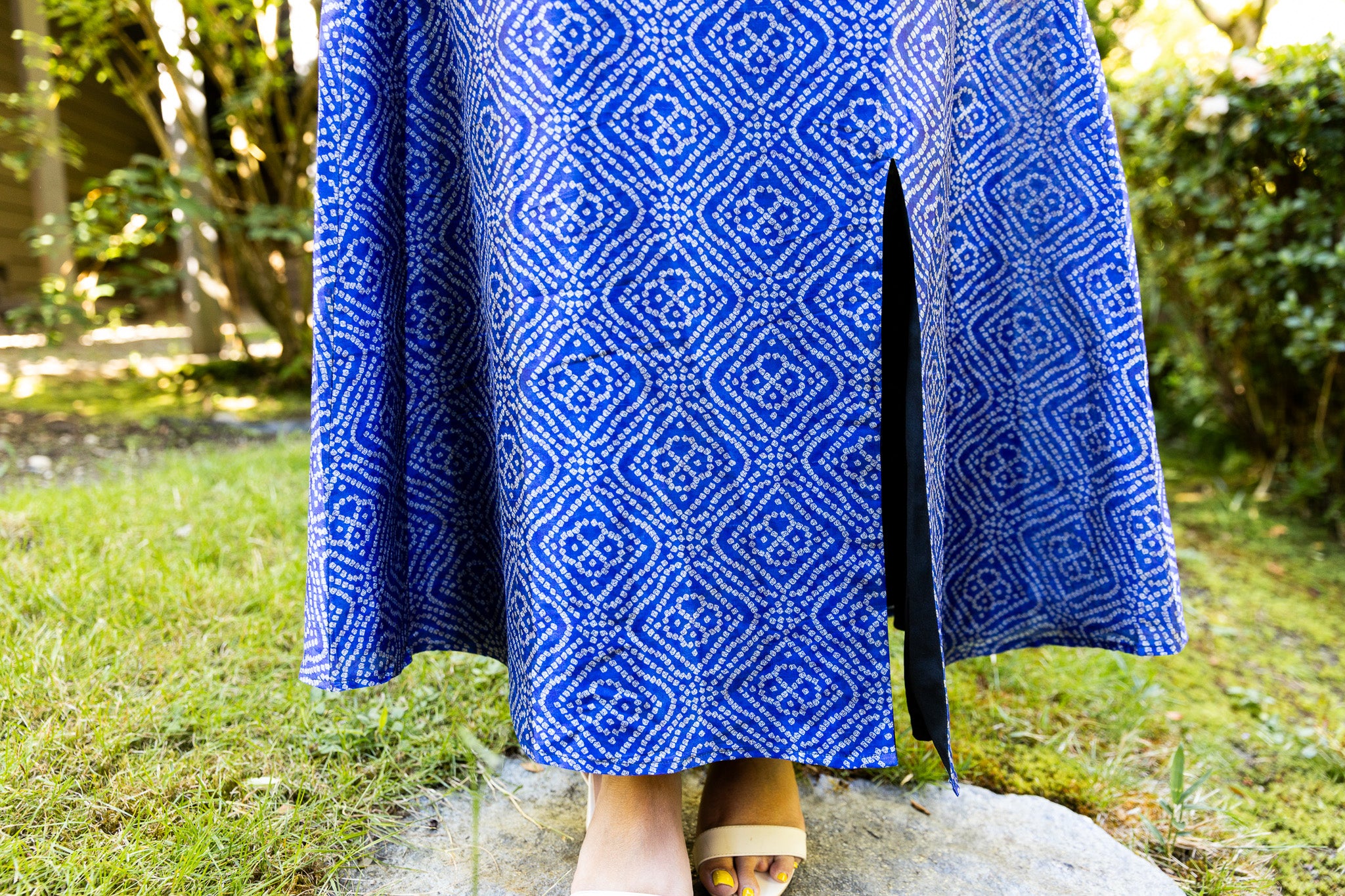 Close-up of the bandhani print and side slit detail on the Indigo Diamond Halter Maxi Dress